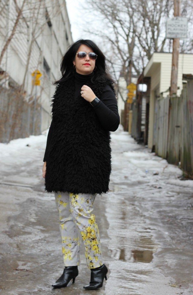 faux fur vest, black turtleneck and printed pants