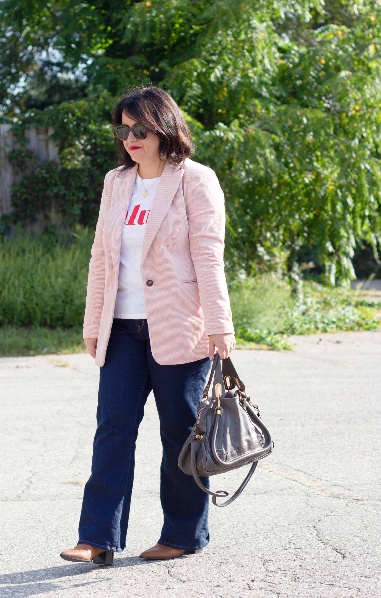 pink corduroy blazer and flare jeans outfit