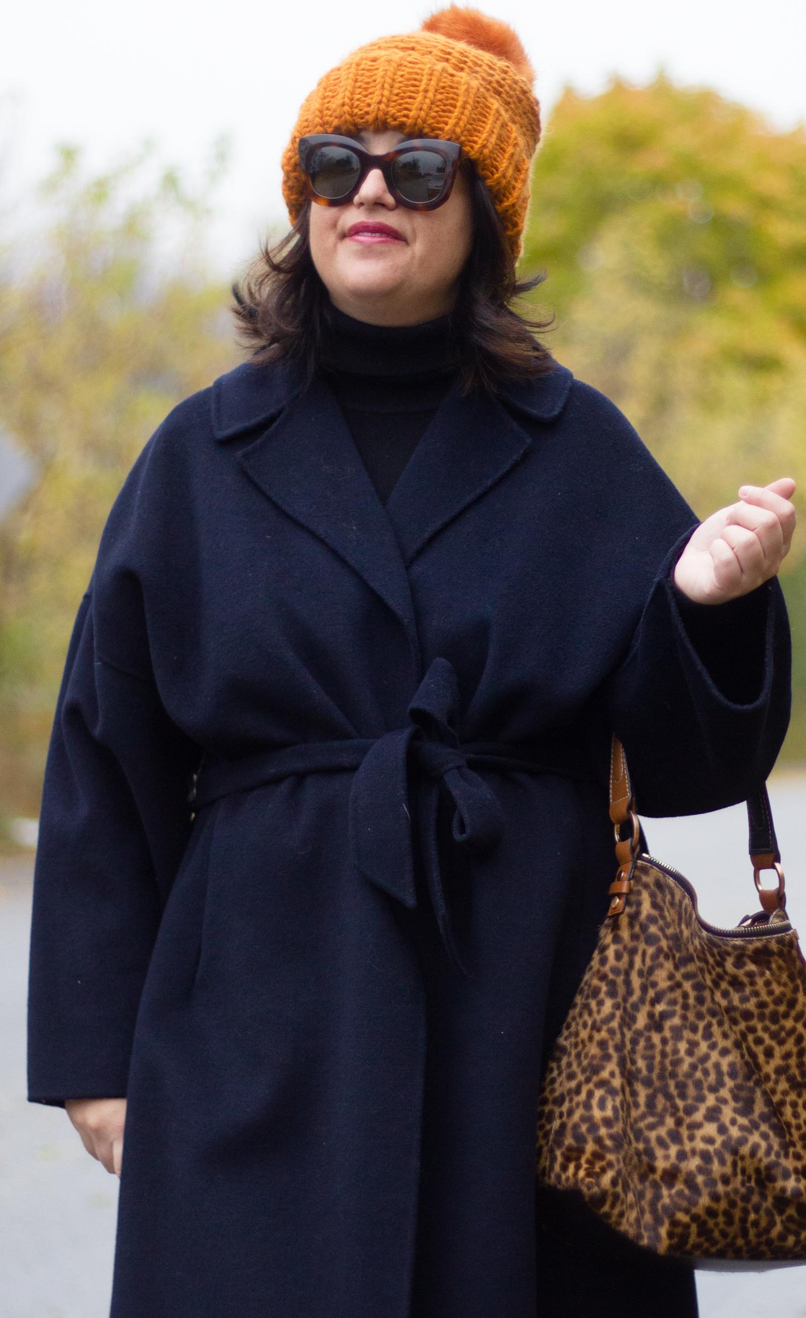 navy wrap coat, leopard bag, burnt orange hat