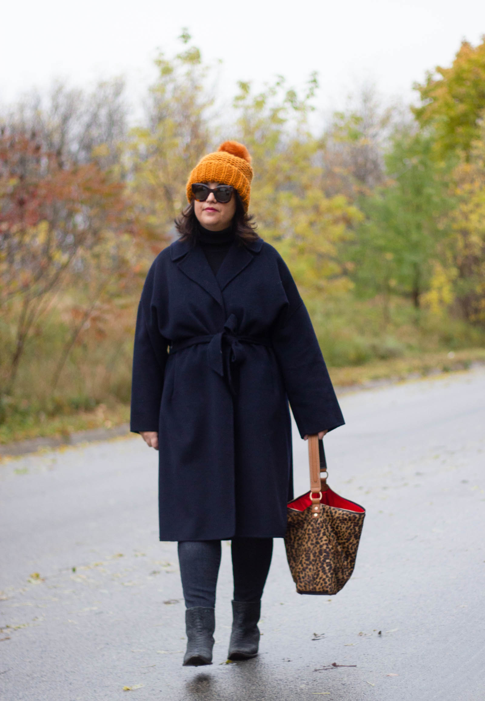 navy wrap coat with black, leopard bag and burnt orange hat