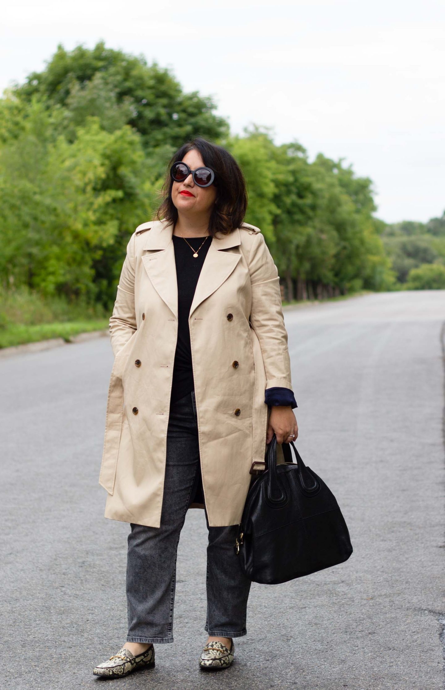 trench coat with washed black jeans and snake loafers