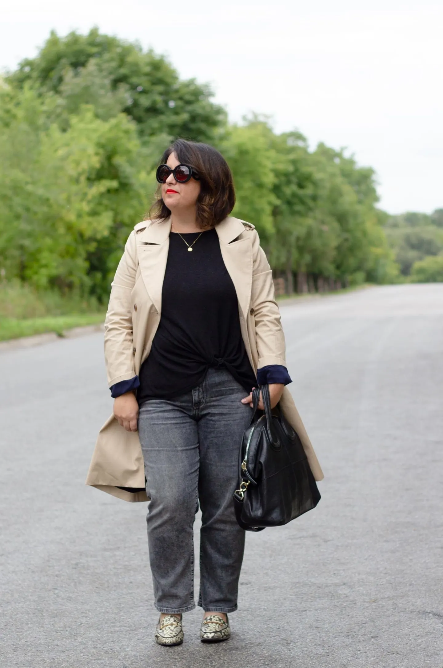 trench coat with black jeans and snake loafers