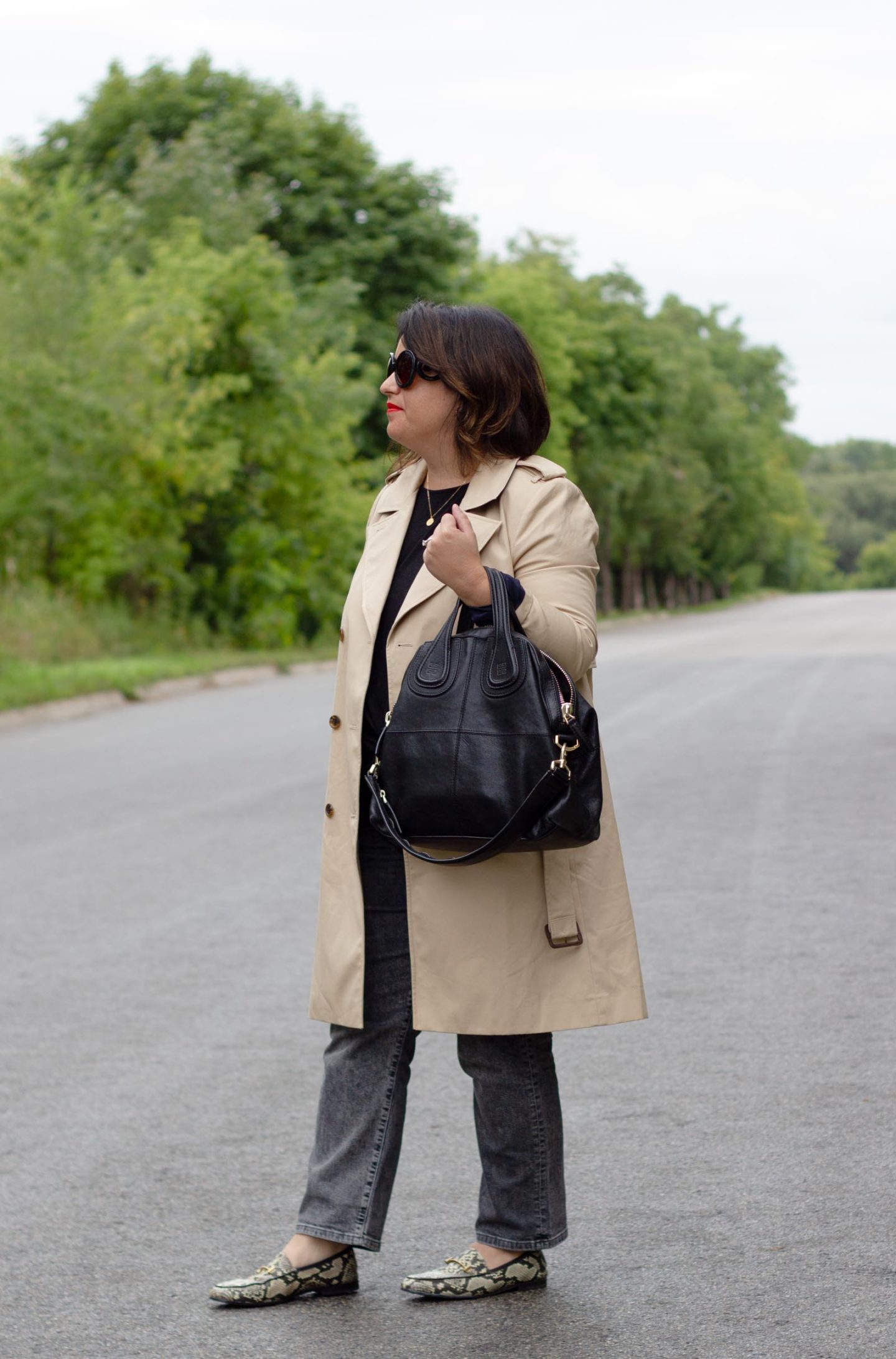 trench coat with black jeans and snake loafers