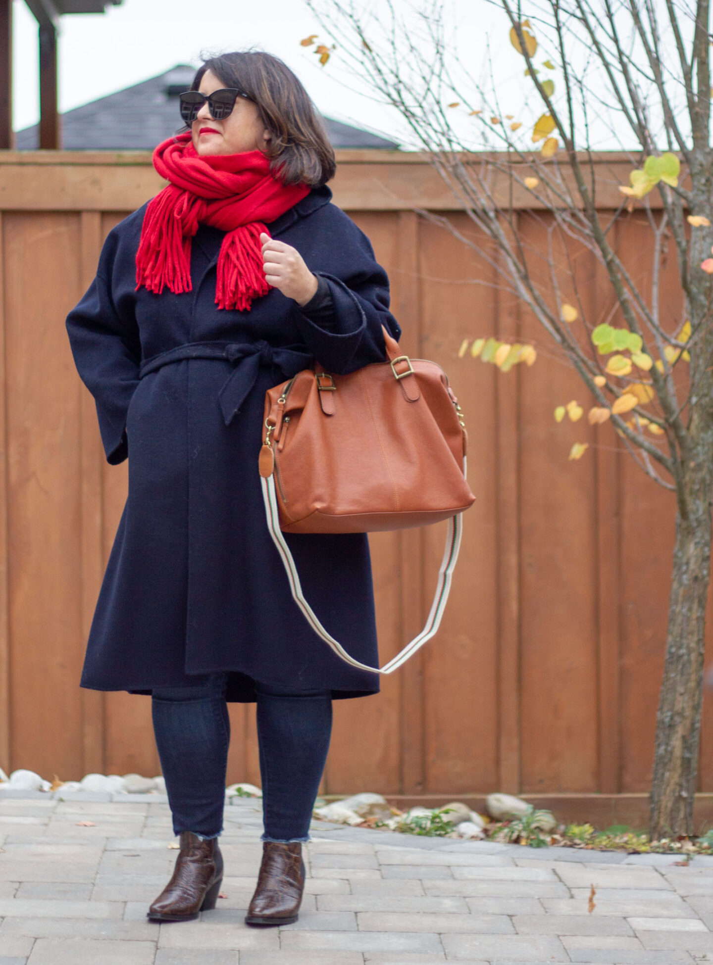 red scarf outfit with navy belted coat