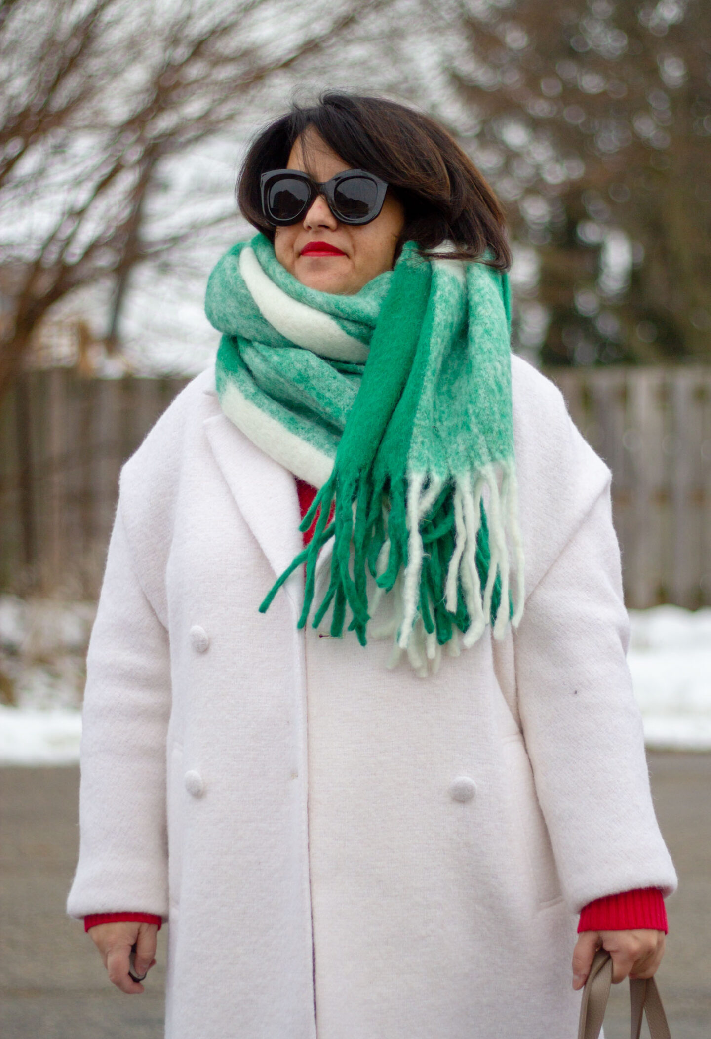 sezane white coat with green scarf and red sweater