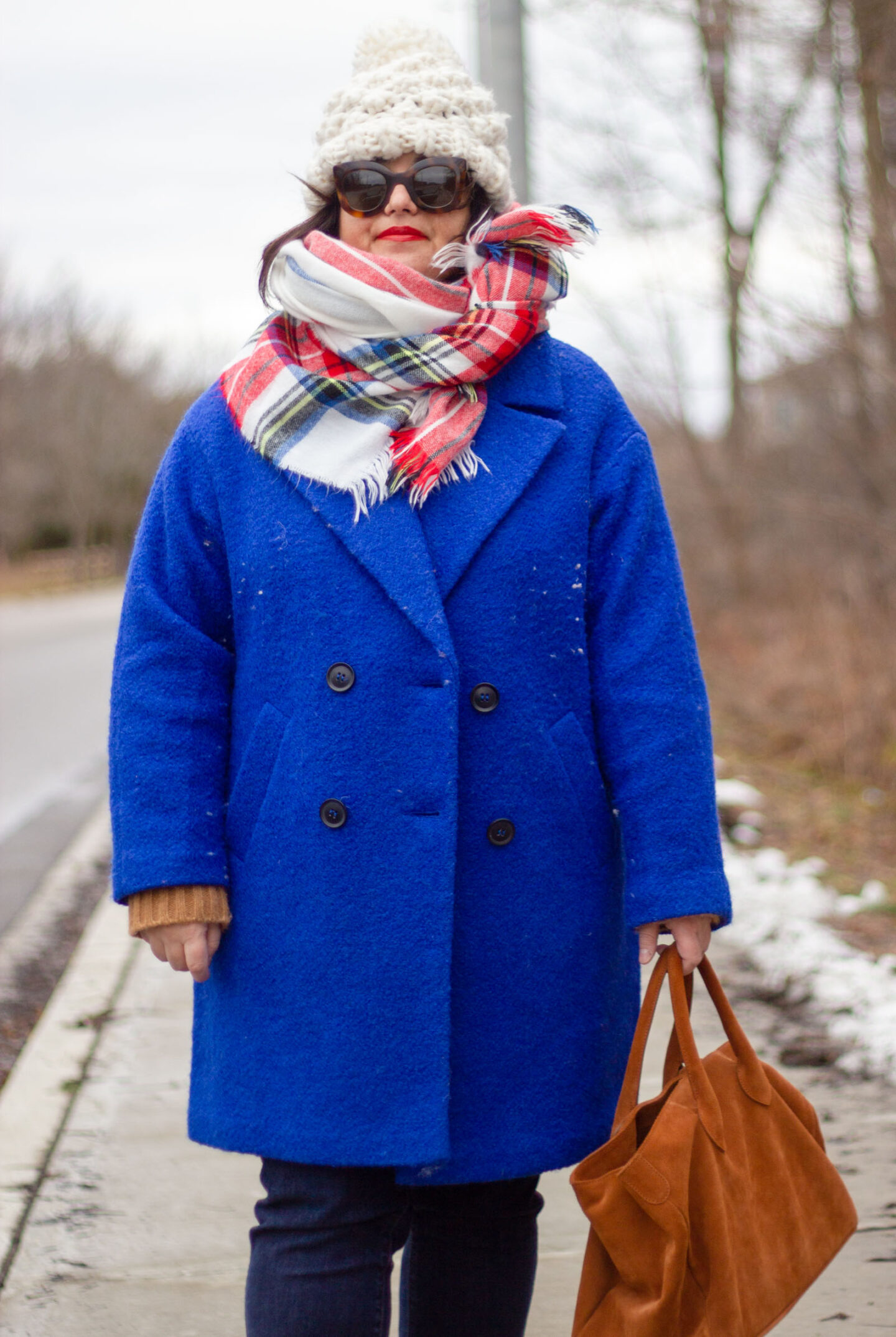bright blue coat with plaid scarf