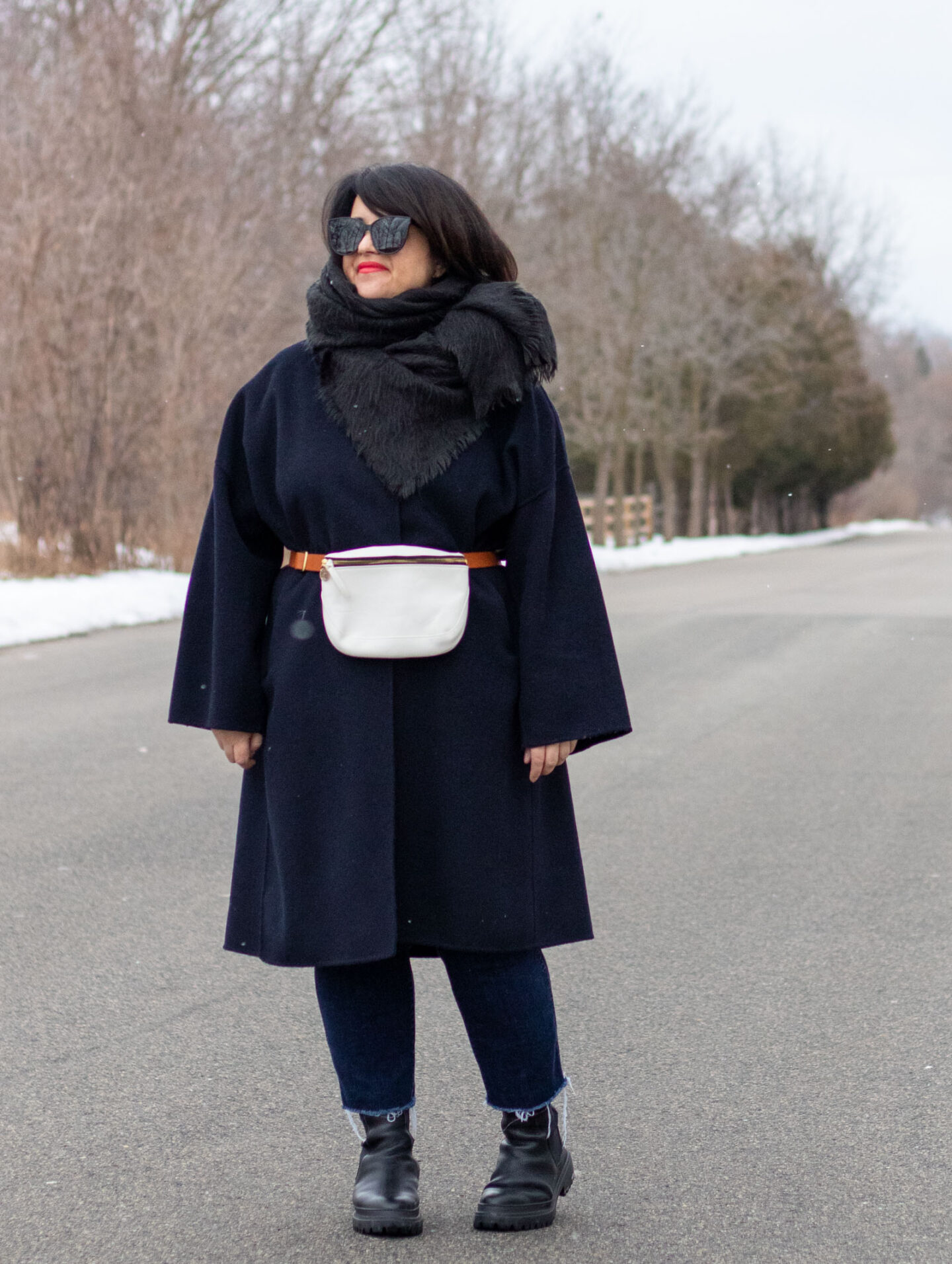 belted navy coat, winter fanny pack outfit