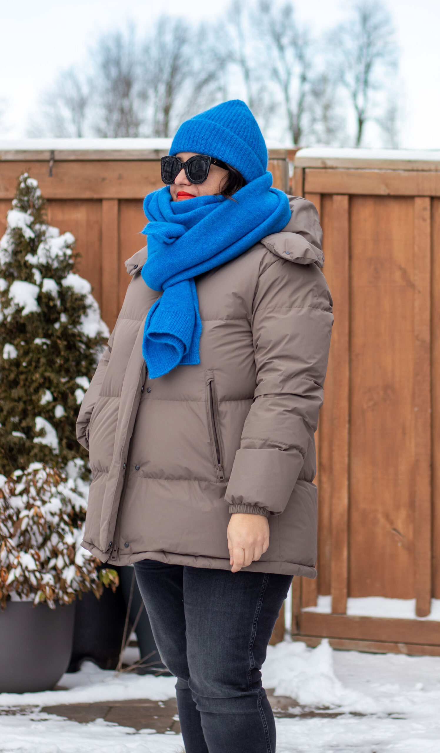 neutral puffer coat bright blue scarf