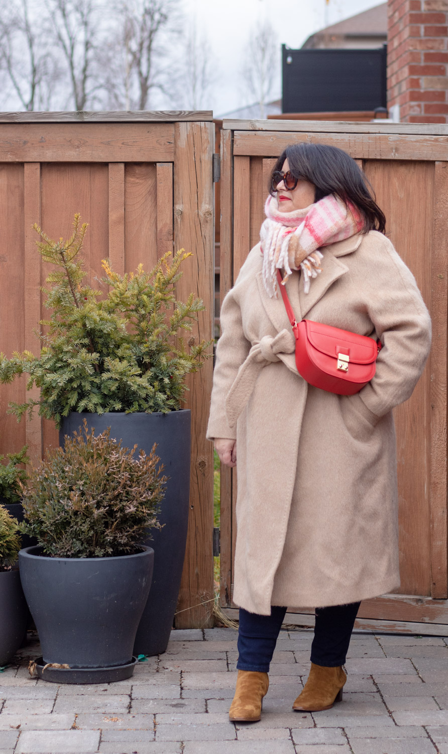 fuzzy camel coat, red bag, soft plaid scarf