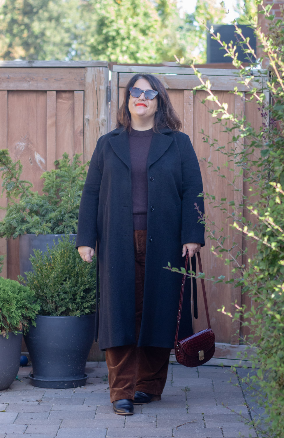 tonal brown outfit with black coat