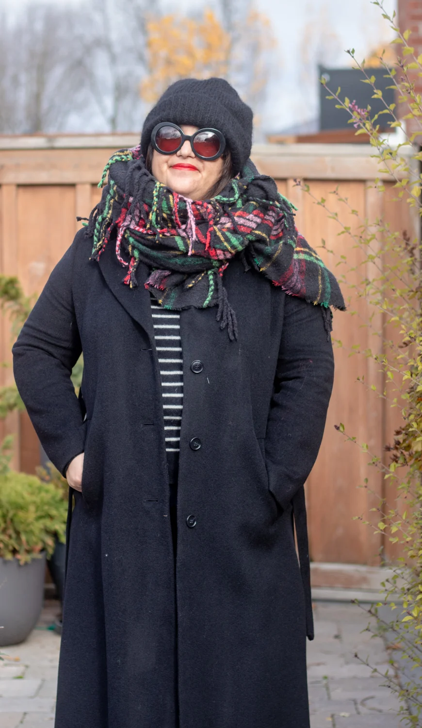 add a plaid scarf to your black coat for a more festive look