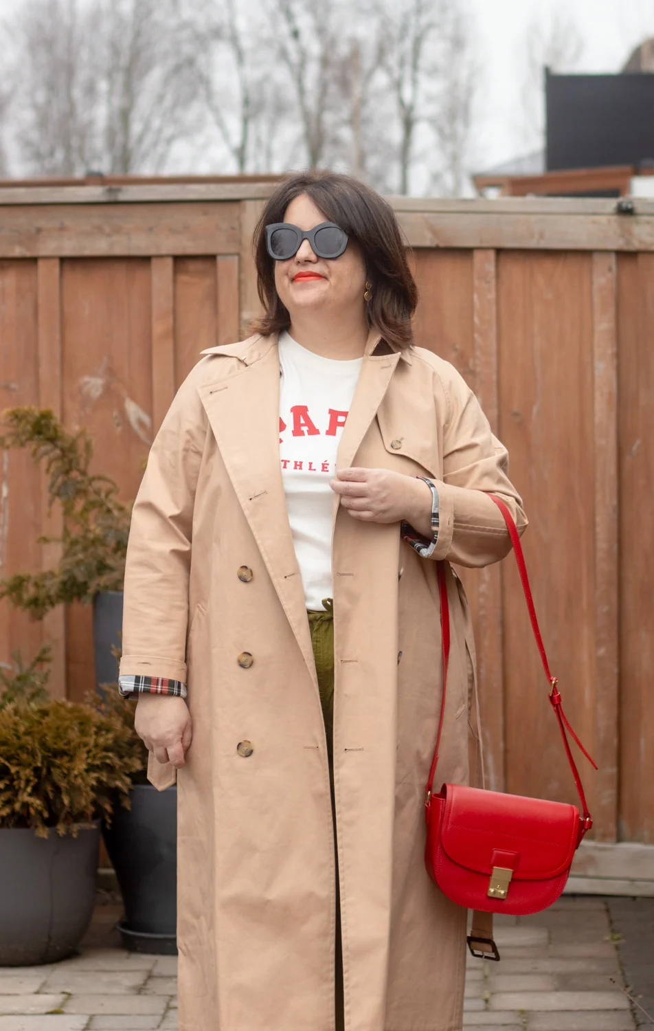 trench coat, green linen wide leg pants, paris tee, red bag