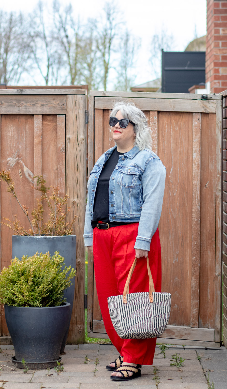 red linen outfit with black tee and jean jacket